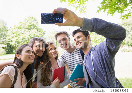 Happy students taking a selfie outside on campus Happy students taking a selfie outside on campus 13603341