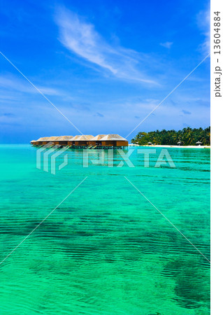 Water bungalows on a tropical island 13604884