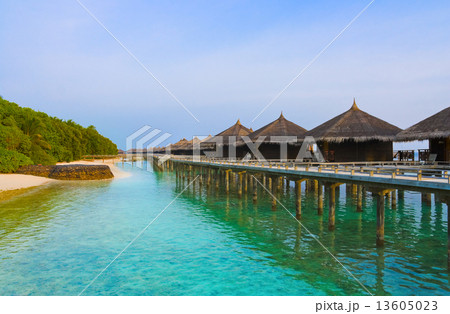 Water bungalows on a tropical island at evening Water bungalows on a tropical island at evening 13605023