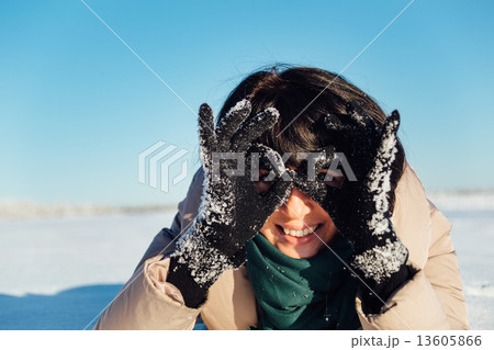 girl lying on the snow and fooling around 13605866