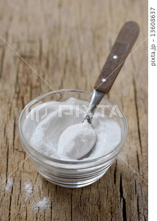 Spoon of baking soda in bowl of baking soda Spoon of baking soda in bowl of baking soda 13608637