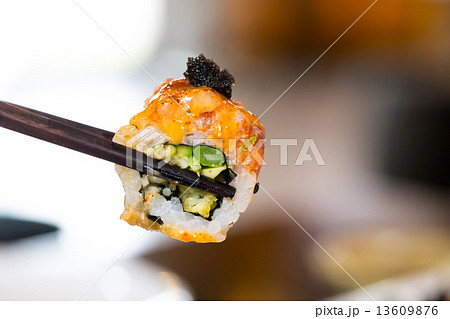 Sushi roll with black chopsticks 13609876