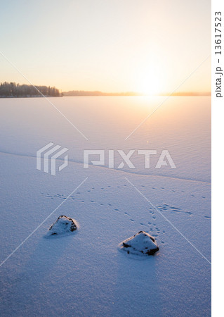 Serene winter morning view to frozen lake 13617523