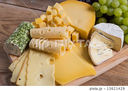 Cheese plate variation on a wooden table 13621429