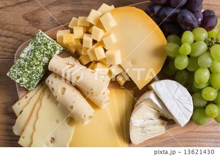 Cheese plate variation on a wooden table 13621430