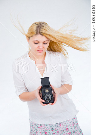 girl on a white background with retro camera 13633365