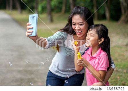 Asian Mother and Daughter in the Park Asian Mother and Daughter in the Park 13633795