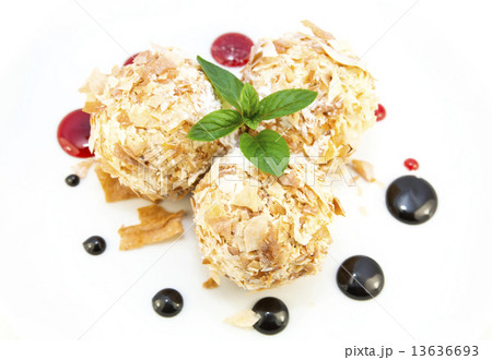 balls of ice cream decorated with mint on a white background in the restaurant 13636693