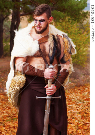 Portrait of a muscular ancient warrior with a sword 13643931