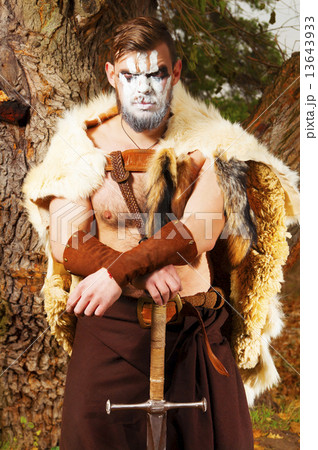 Portrait of a muscular ancient warrior with a sword 13643933