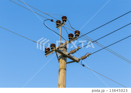 Old wooden power transmission pole with wires 13645023