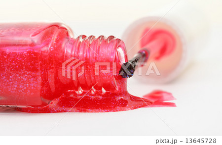 bottle with spilled pink nail polish close up 13645728