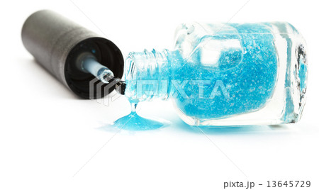 bottle with spilled blue nail polish on white bottle with spilled blue nail polish on white 13645729