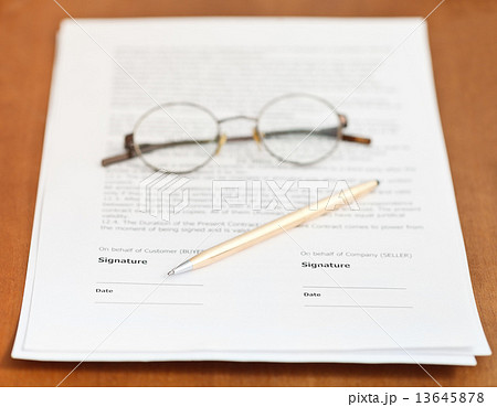 contract, golden pen and eyeglasses on table 13645878