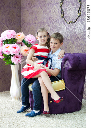 boy and girl sitting in the nice room 13646073