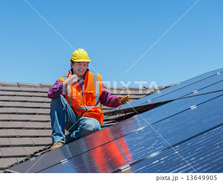 worker and solar panels worker and solar panels 13649905