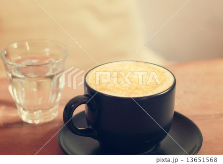 Hot cup of caramel macchiato with glass of water, retro filter e Hot cup of caramel macchiato with glass of water, retro filter e 13651568