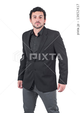 Young man in black jacket poses at studio 13652417