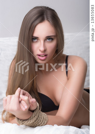 model tied up with fetish restraint rope. model tied up with fetish restraint rope. 13655083