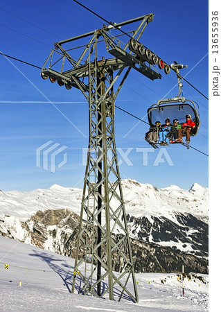 Father and tree kids on ski in the cable car cabin 13655936