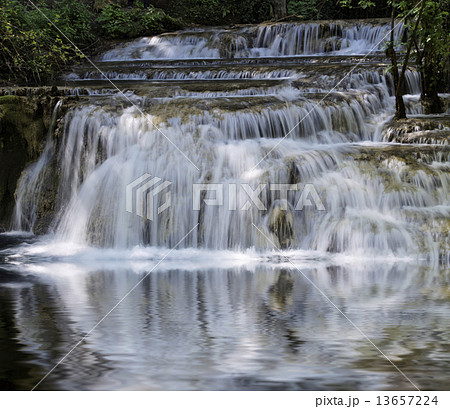 Scenic waterfall with white water cascading over rocks Scenic waterfall with white water cascading over rocks 13657224