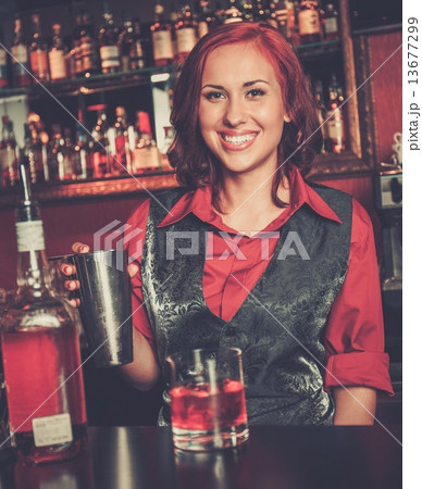 Beautiful redhead barmaid making cocktail Beautiful redhead barmaid making cocktail 13677299