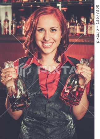 Beautiful redhead barmaid behind bar counter 13677300