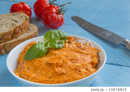 Herb butter tomato in a bowl on wood 13678825