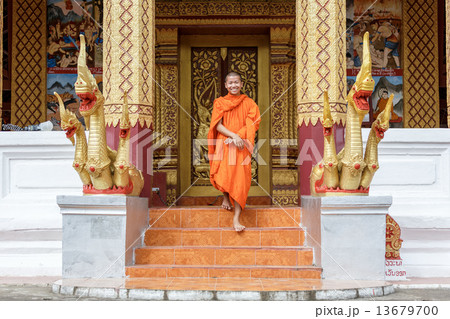 Young Buddhist Monk Walking In Front Of Monastery 13679700