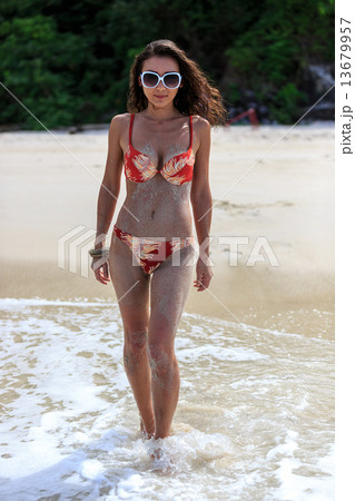 Beautiful woman walking on the beach Beautiful woman walking on the beach 13679957