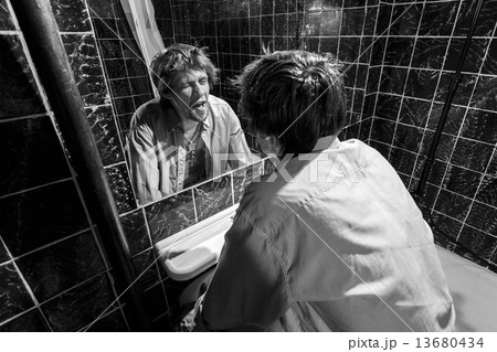Drunk Man looks at himself in the mirror 13680434