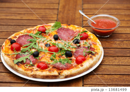 Delicious italian pizza served on wooden table Delicious italian pizza served on wooden table 13681499