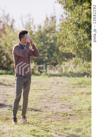 An apple orchard in Utah. Man taking a picture. 13682292
