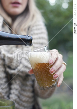 An apple orchard in Utah. Woman pouring a glass of cider. An apple orchard in Utah. Woman pouring a glass of cider. 13682325