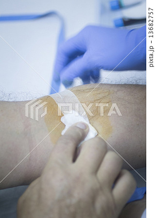 Nurse and male patient blood sample donation 13682757