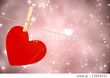Composite image of heart hanging on line 13684032