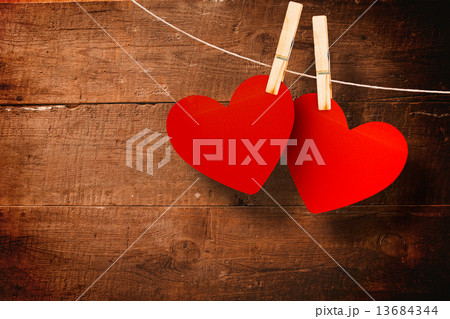 Composite image of hearts hanging on line 13684344