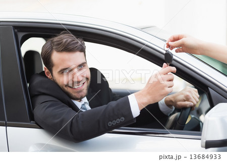 Businessman sitting in drivers seat Businessman sitting in drivers seat 13684933