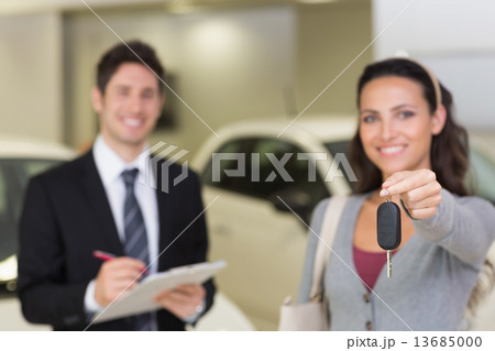 Female driver showing a key after bying a new car 13685000