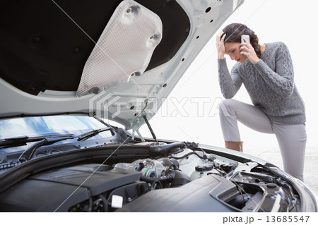 Desperate woman calling for assistance after breaking down Desperate woman calling for assistance after breaking down 13685547