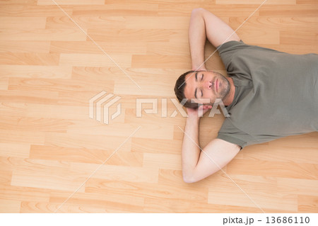 A man lying on floor at home A man lying on floor at home 13686110