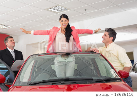 Woman having fun in her new red convertible 13686116