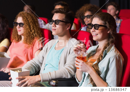 Young friends watching a 3d film Young friends watching a 3d film 13686347