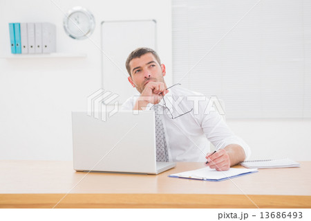 Worried businessman writing on is notepad 13686493