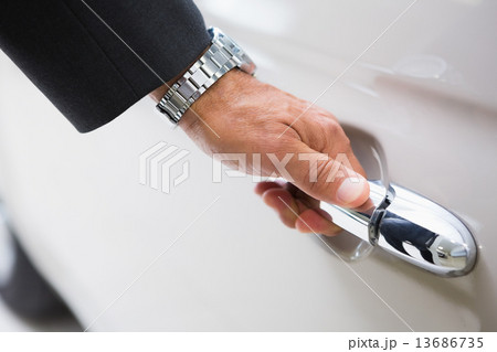 Man holding a car door handles Man holding a car door handles 13686735