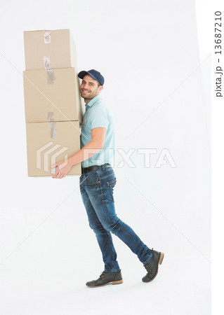 Delivery man carrying cardboard boxes Delivery man carrying cardboard boxes 13687210