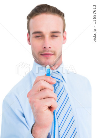 Smiling businessman in shirt holding a cable 13687613