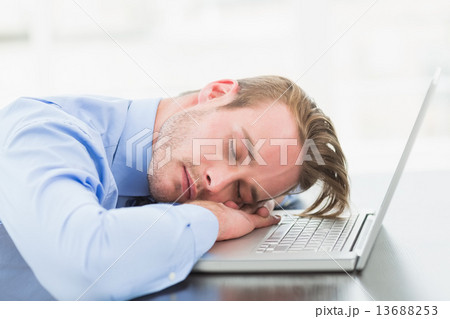 Businessman sleeping on his laptop Businessman sleeping on his laptop 13688253