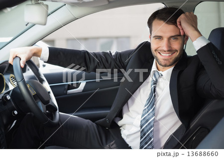 Businessman sitting in drivers seat Businessman sitting in drivers seat 13688660