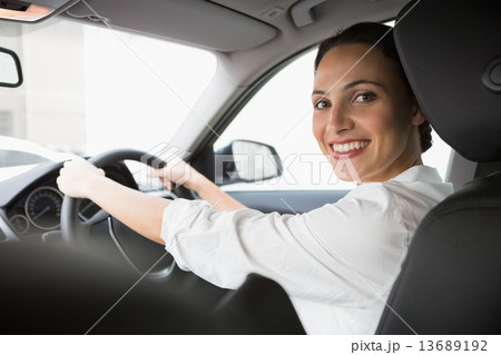 Woman smiling at camera while driving 13689192